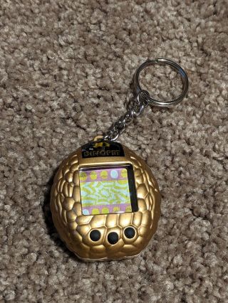 1997 Nano Dino Pet Virtual Pet Giga Pets Tamagotchi Gold Egg Shape Rare 2