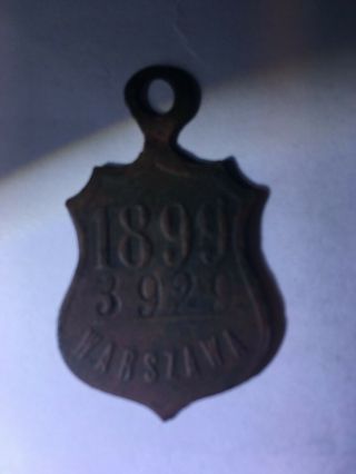1899 DOG TAX TAG,  WARSAW POLAND,  DOG ' S HEAD OVER THE DATE ON FRONT,  RARE TAG 3