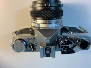 Olympus OM - 2 35mm Camera.  C/W 50mm F/1.  8 lens & rare detach hot shoe.  “Lot 123” 3