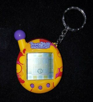 2004 Tamagotchi Connection V1.  1 Yellow / Red Pattern Purple Buttons Rare Bandai