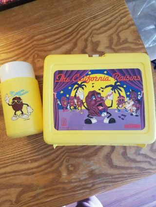 California Raisins memorabilia.  Lunch box with thermos.  Figurines. 3