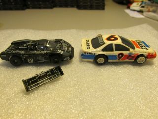 (6) Aurora Tomy cars with extra chassis & parts, 5