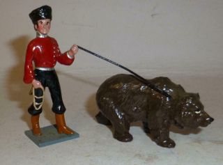 Unidentified White Metal Model Of A Russian With A Bear On A Lead