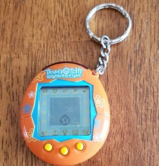2004 Bandai Tamagotchi Connection Virtual Pet Orange Stars Video Game