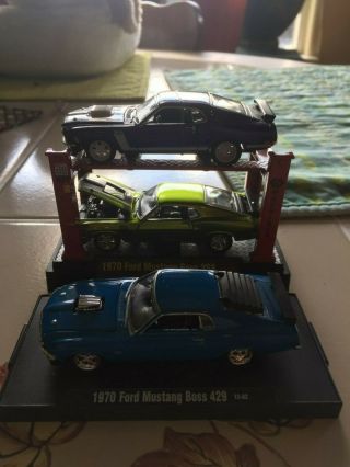 M2.  1970 Ford Mustang Boss 302 Auto Lift.  &1970 Ford Mustang Boss 429.
