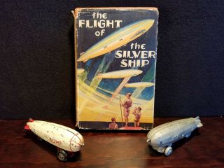 2 Vintage Art Deco Cast Metal Blimp Toys & Vintage Silver Ship Zeppelin Book