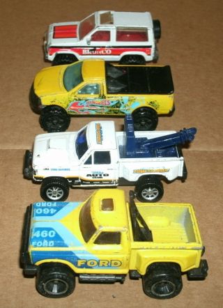 Four 1/64 Scale Ford Diecast 4x4 Trucks - F150 And Bronco Ii - Mbx Hw And Maisto