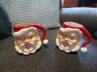 2 Vintage American Bisque Pottery Winking Santa Claus Mugs/cups.