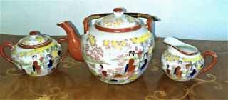 Occupied Japan Porcelain Teapot,  Sugar,  & Creamer,  With One Teacup & Saucer.