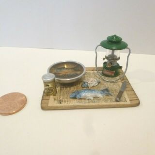 Miniature Wood Board With Lantern,  Fish Being Cut And In Bowl On Newspaper