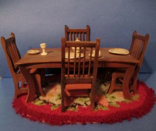 Doll House Wood Dining Room Table With Four Chairs And An Oval Area Rug