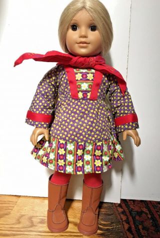 American Girl Doll With Long Blonde Hair And Brown Eyes Wearing Clothes