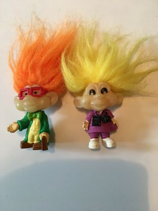 Two Troll Dolls One Is A Professor.  Other Is A Tourist.
