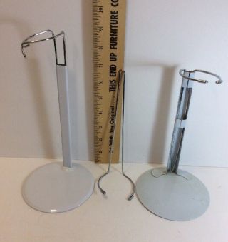 Two White Metal Adjustable Doll Stands And One Extra Wire Insert