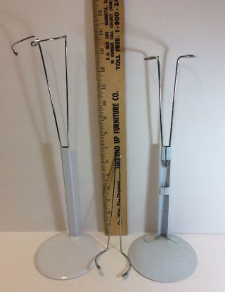 TWO WHITE METAL ADJUSTABLE DOLL STANDS AND ONE EXTRA WIRE INSERT 3