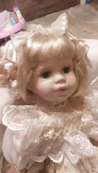 Ashley Belle Collectible Porcelain Doll Sitting.